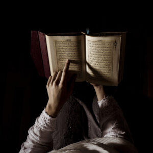 Silhouette of a Muslim woman reading Quran — online Quran classes for ladies at The Quran Nest